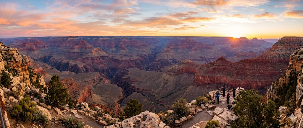 Grand Canyon panoramic sunrise view with orange and pink layered rock formations 2026